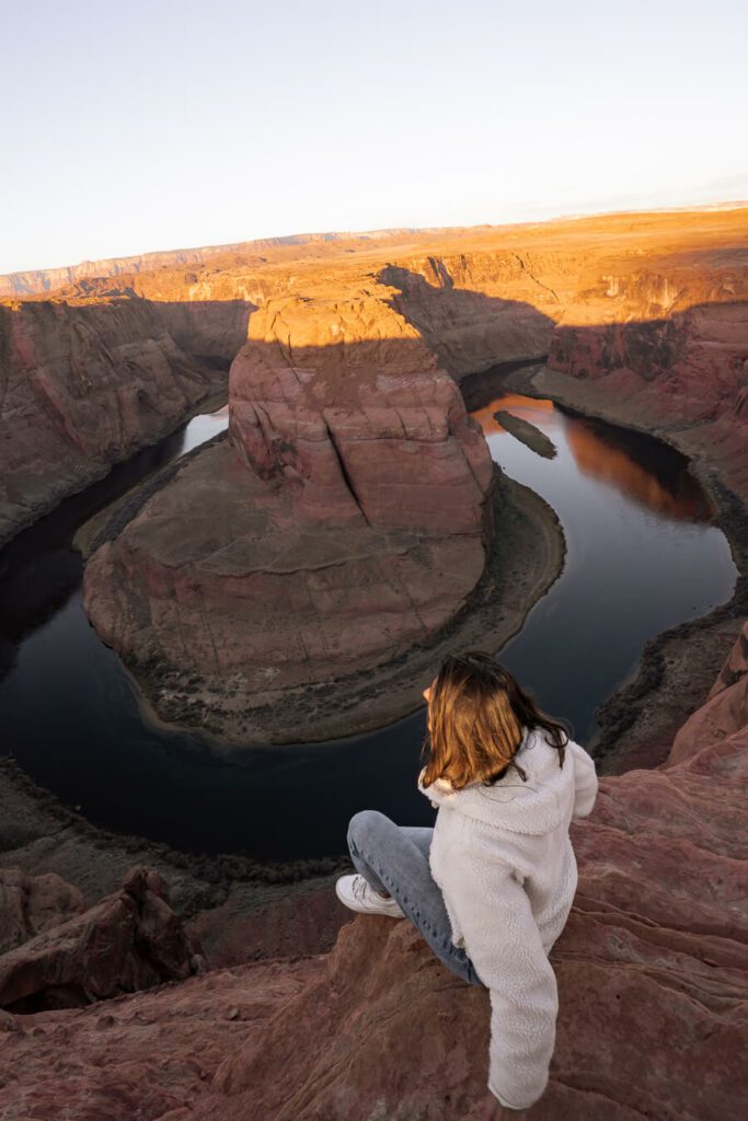 woman watching a horseshoe bend sunrise