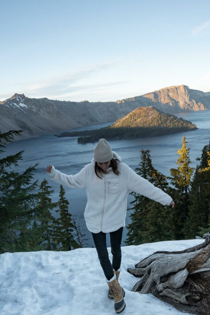 woman at crater lake national park in the snow
