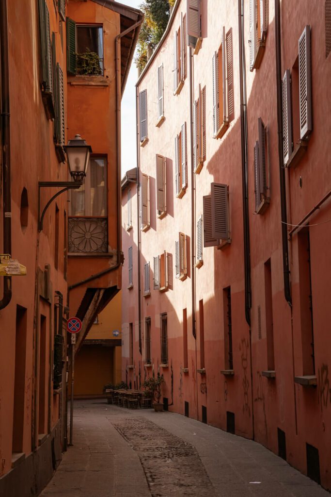 a pink and orange street in bologna italy