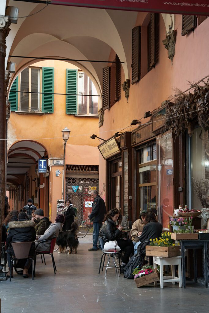 a portico lively with people in bologna italy