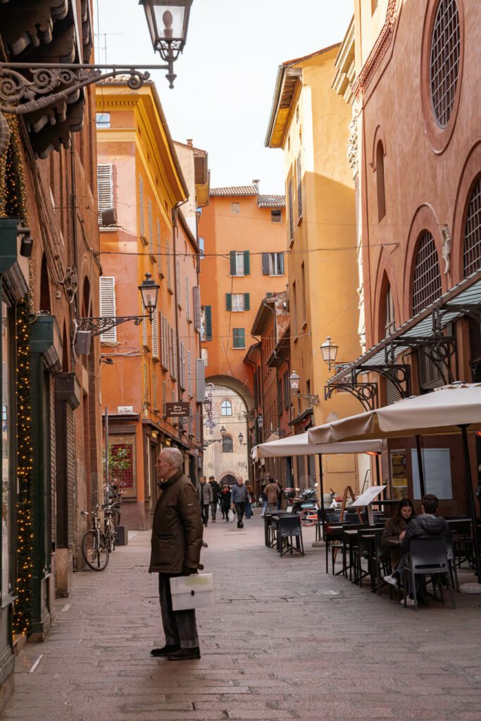 man on a shopping street in bologna