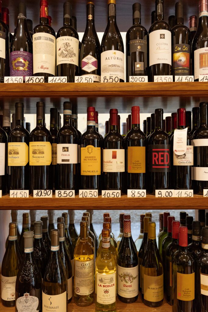 wine bottles on a shelf in italy