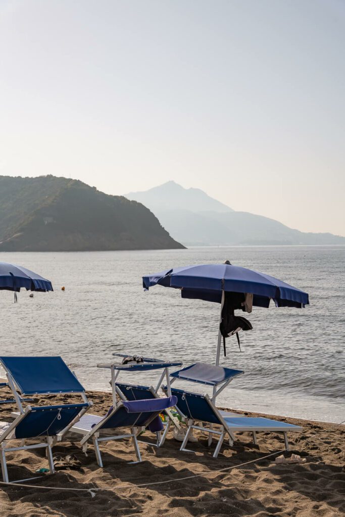 beach with parasol in procida italy