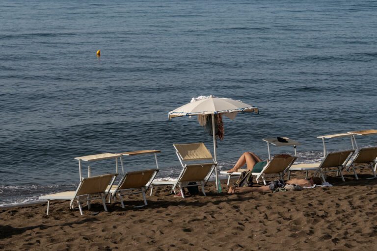 loungers on the beach in procida