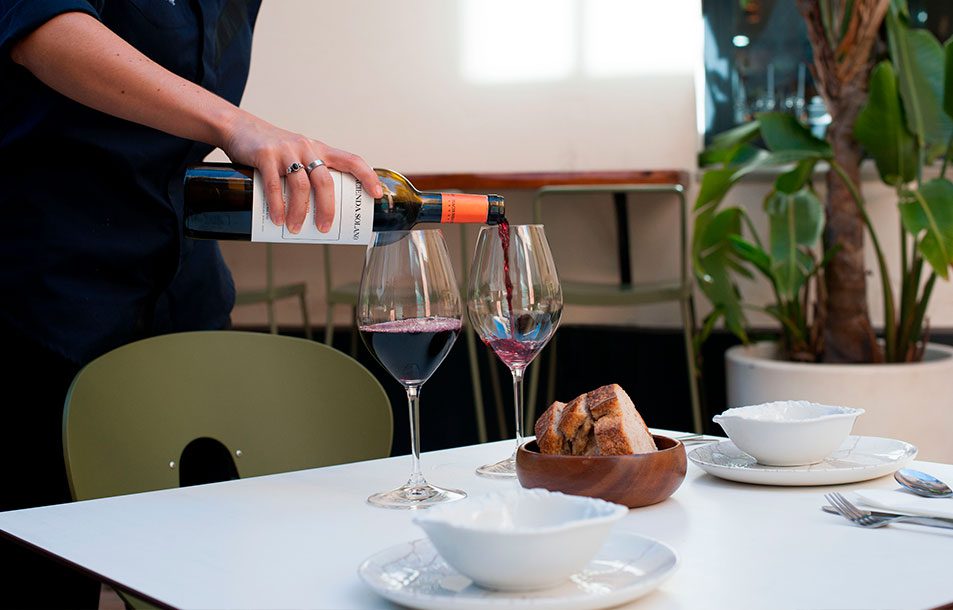 waiter pouring wine in a top seville restaurant
