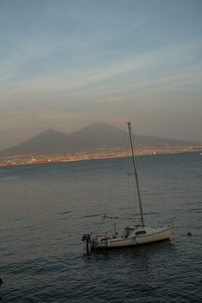 bay of naples, boat with Vesuvius volcano
