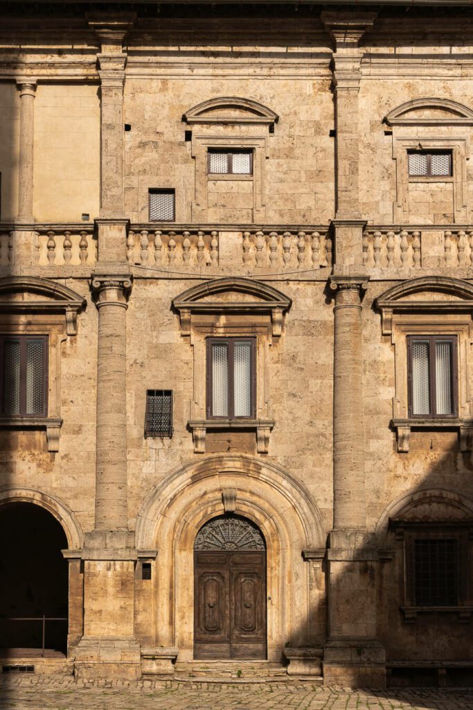 a sunlit palace facade in a small town in tuscany