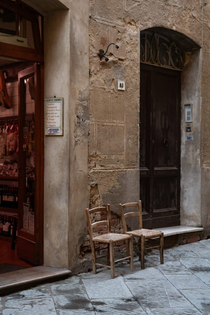 two antique chairs outside a shop in tuscany
