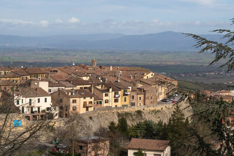 view of montepulciano italy with rolling hills and valley beyond