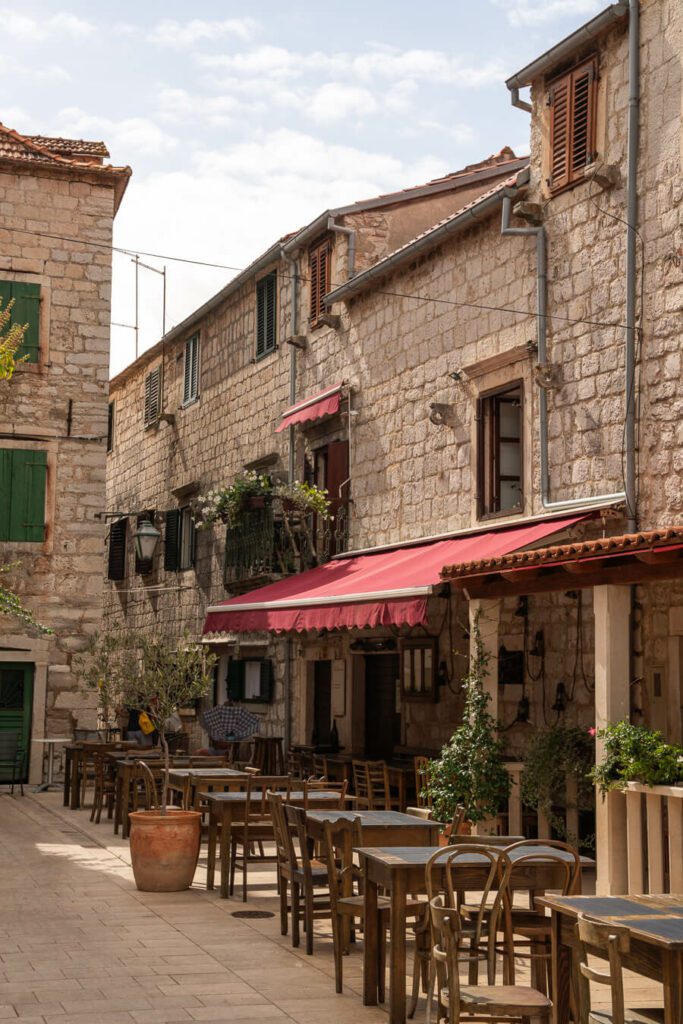 old street with outdoor dining seating in hvar