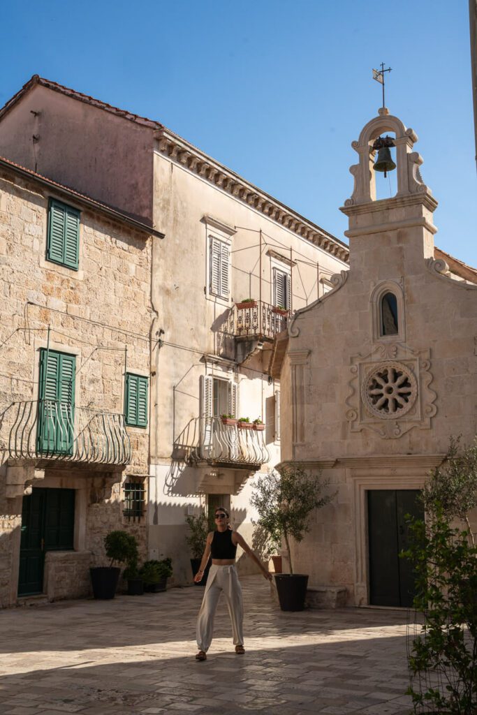 woman, me exploring a cute corner with old buildings in Jelsa, Hvar
