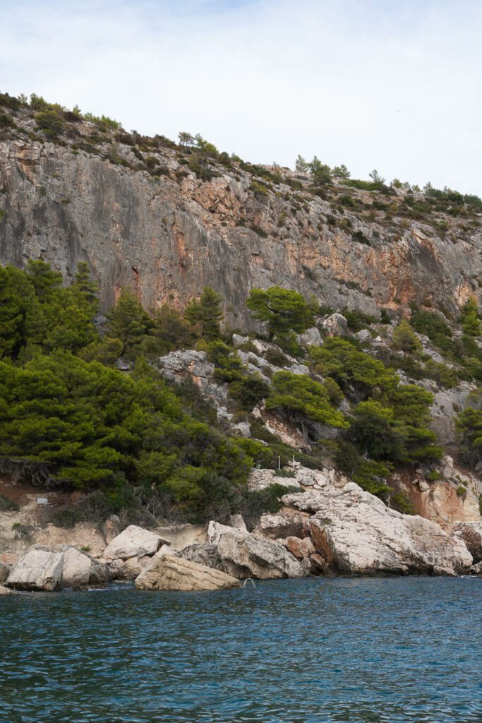 beaches on hvar, a rocky cliff with sea
