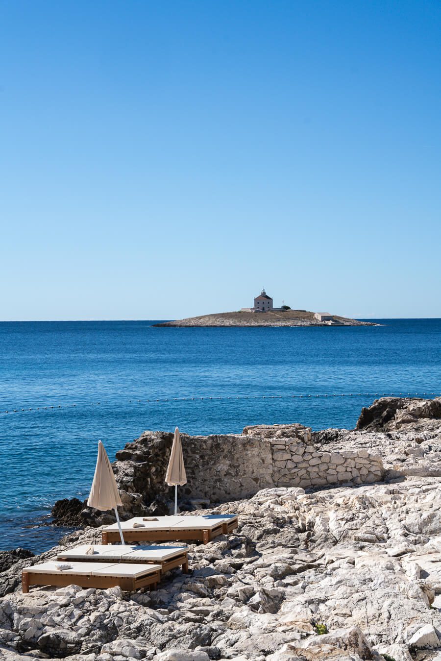 loungers and distance island on Pokonji Dol Beach hvar