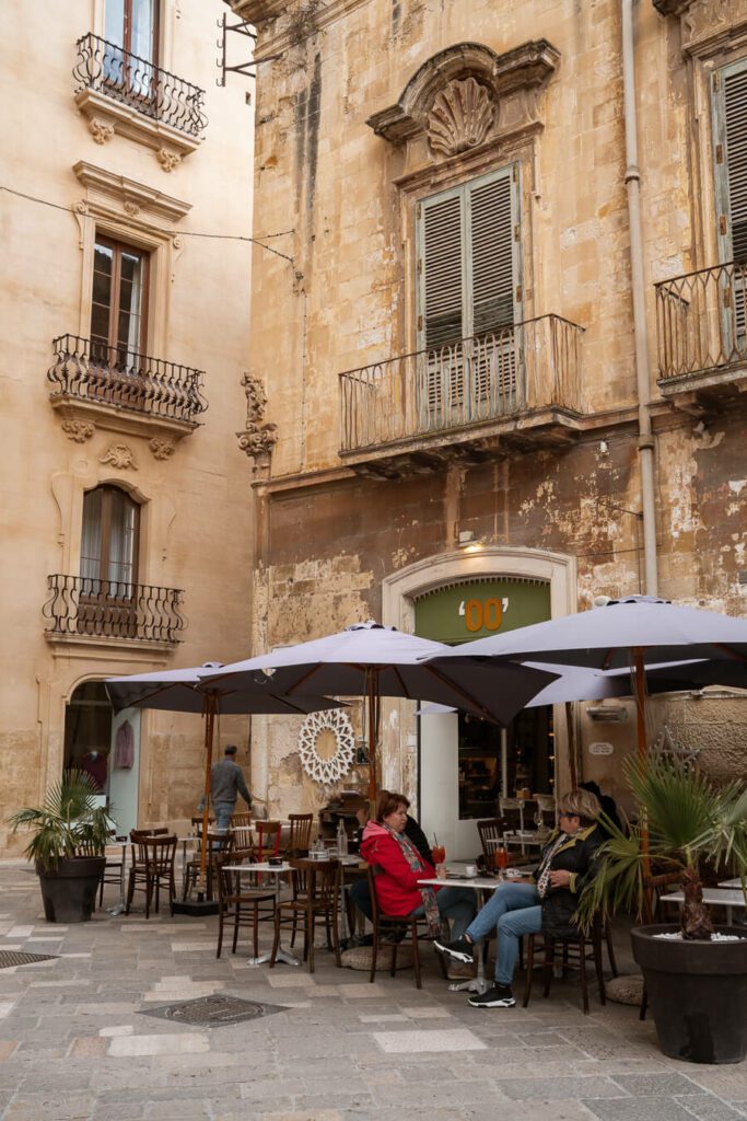 side street with restaurant and outdoor seating in lecce