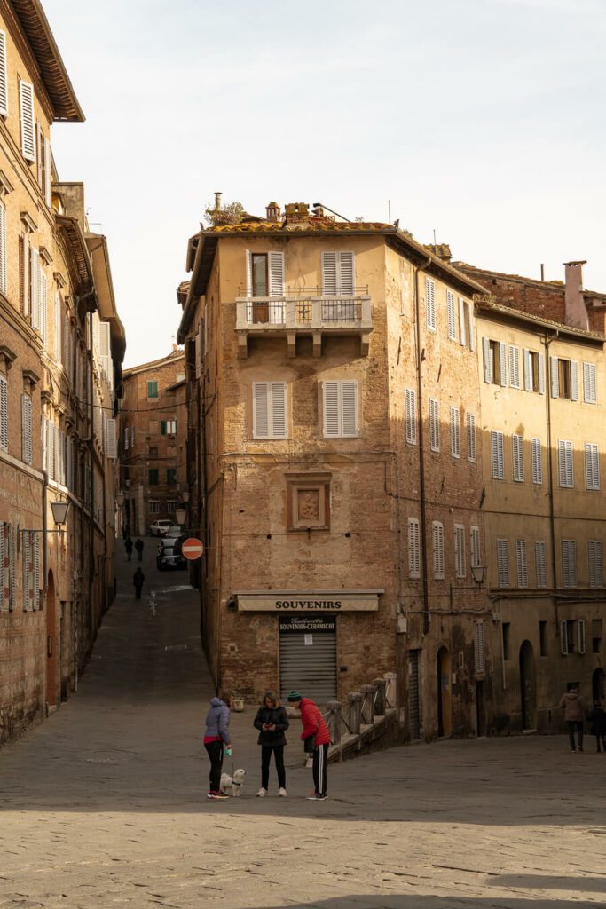 street corner with locals in siena itlay