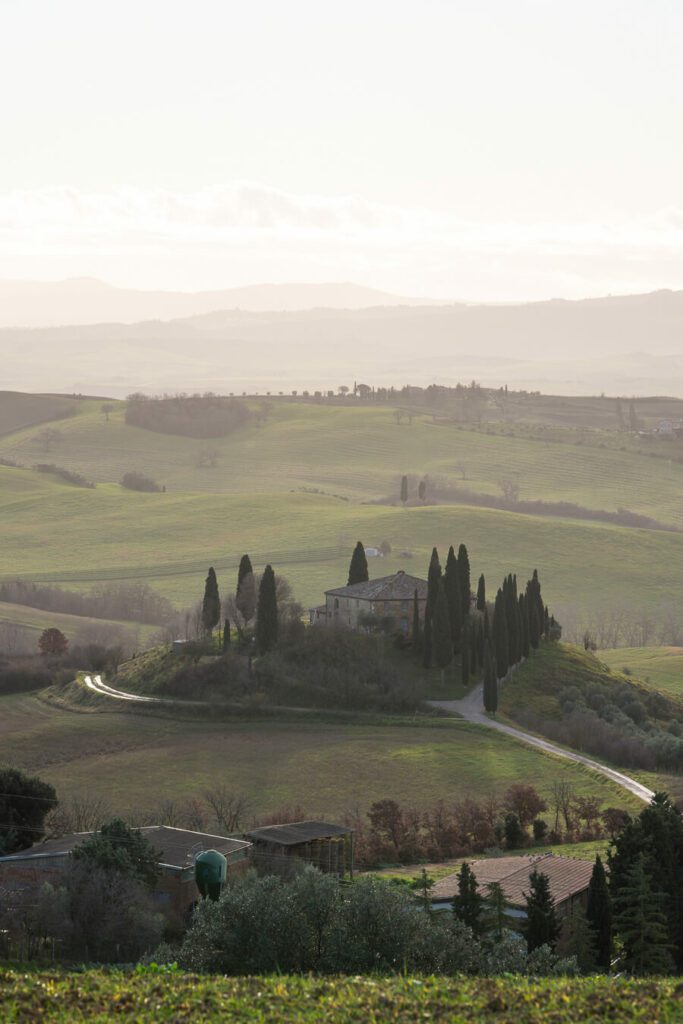 a hilltop house in the rolling hills of tuscany