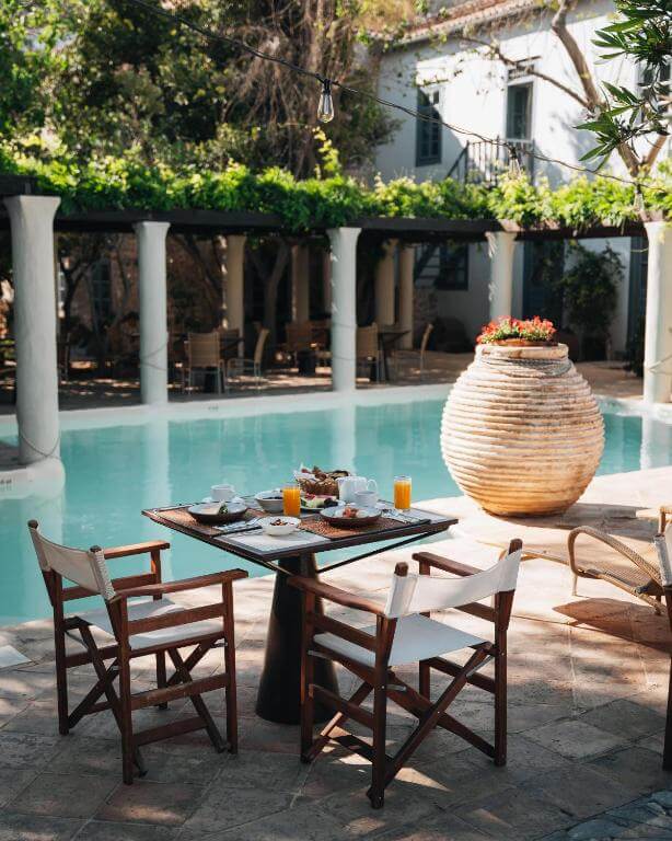 breakfast set up at pool in hotel in hydra greece