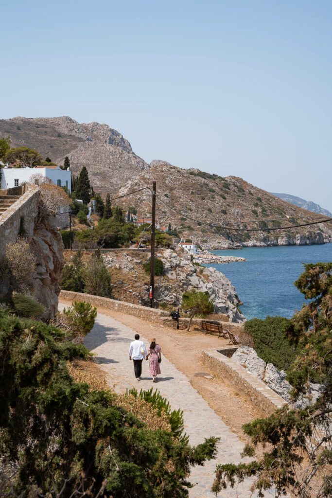 couple walking the coastal walk in hydra greece
