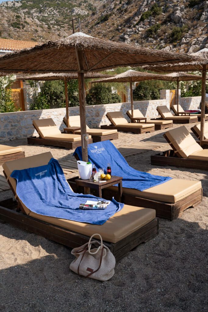 beach loungers with drinks at mandraki beach resort