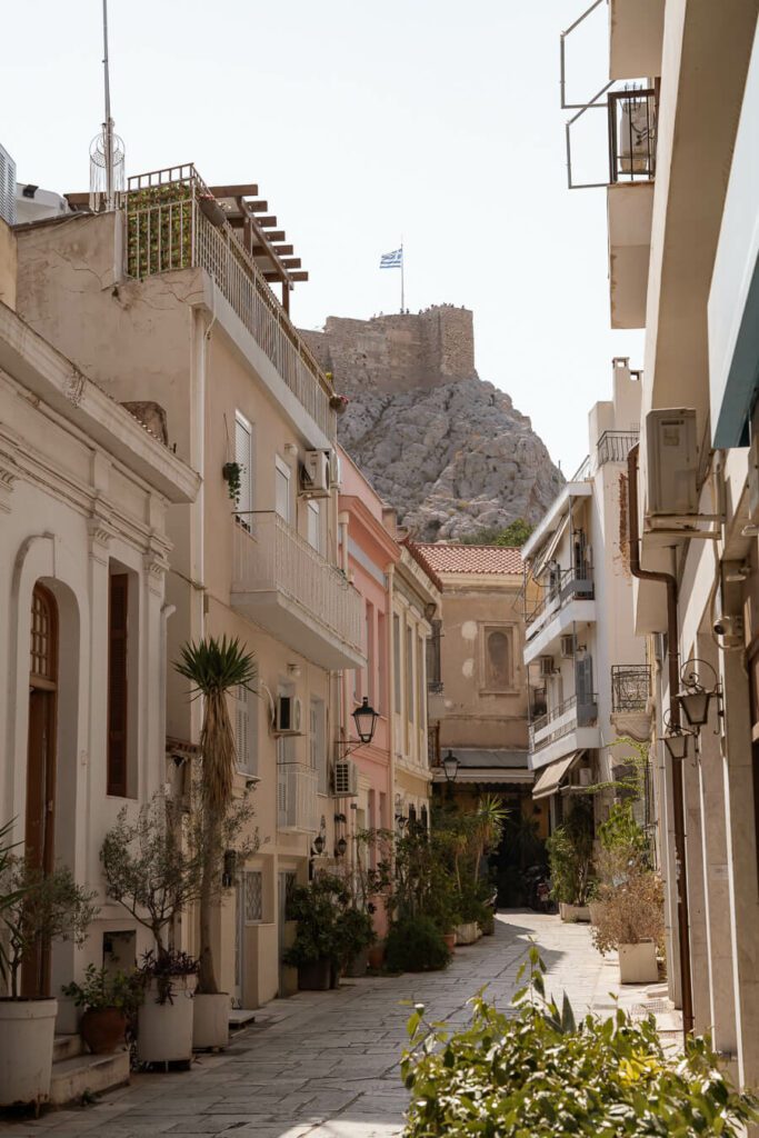 a street in plaka with acropolis athens