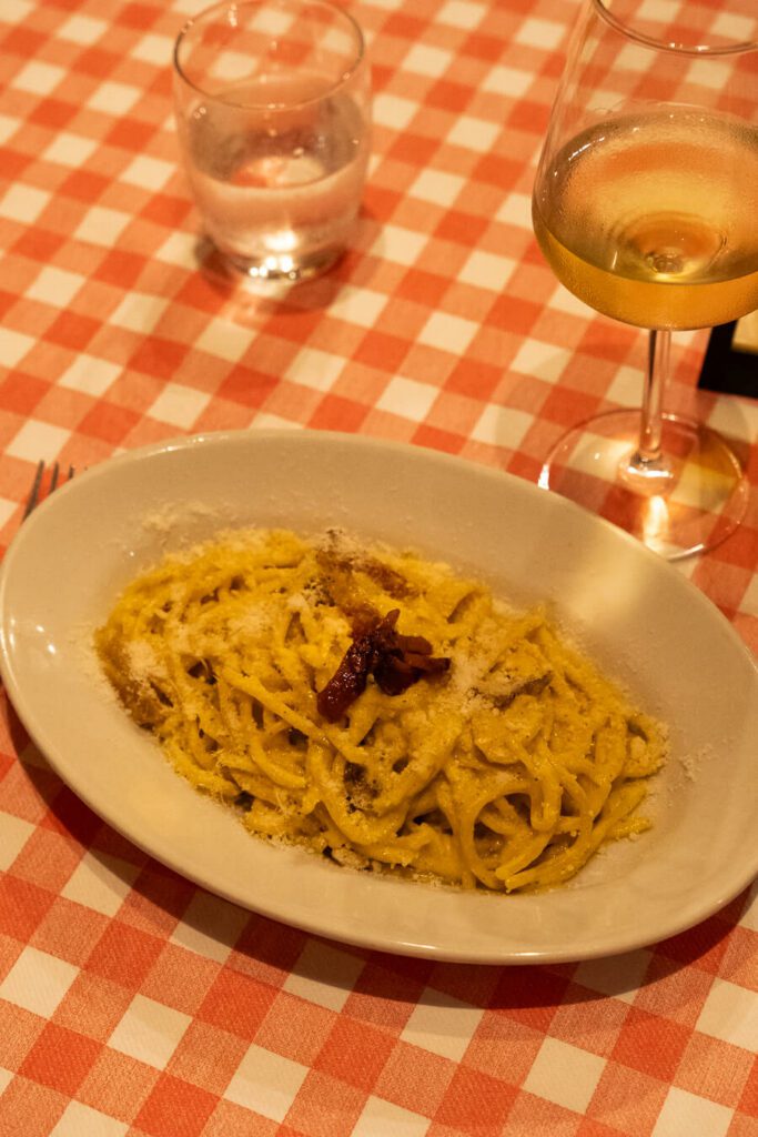 carbonara and wine in trastavere rome restaurant