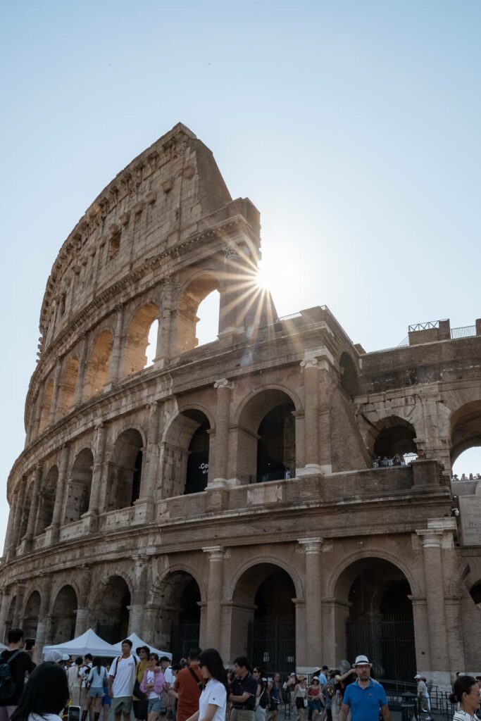 colosseum in rome with sun flair
