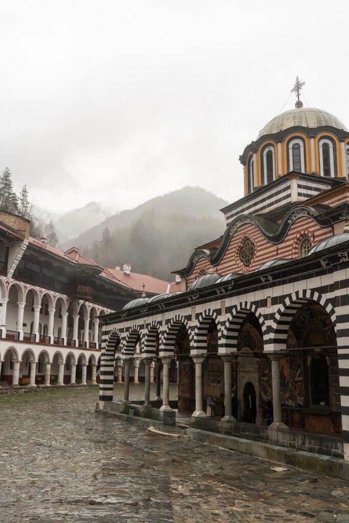 rila monastery shrouded in fog and rain