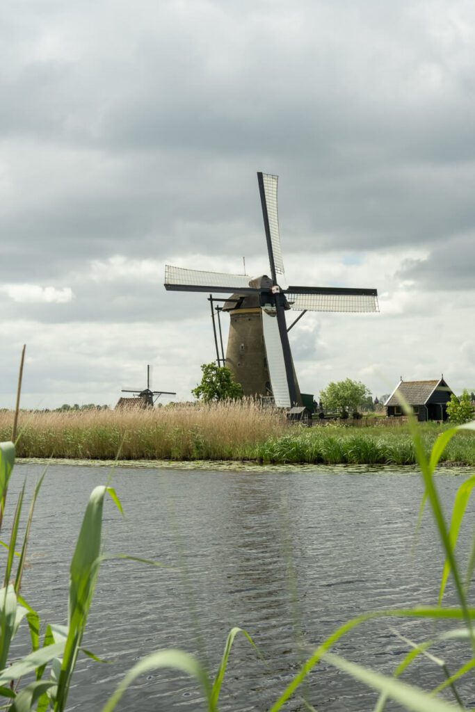 a windmill in kinderdijk on an overcast day