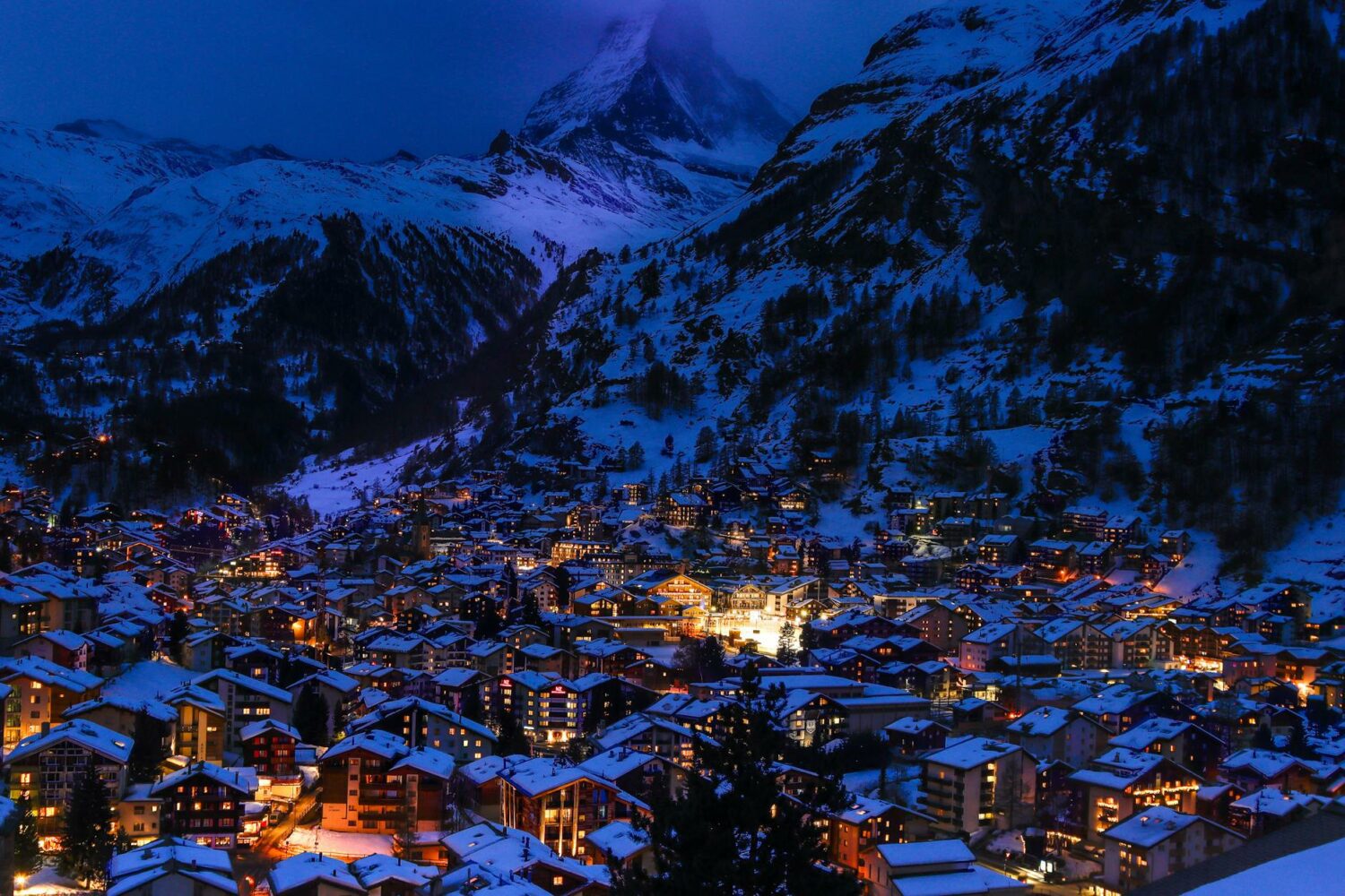 illuminated town houses in mountain landscape