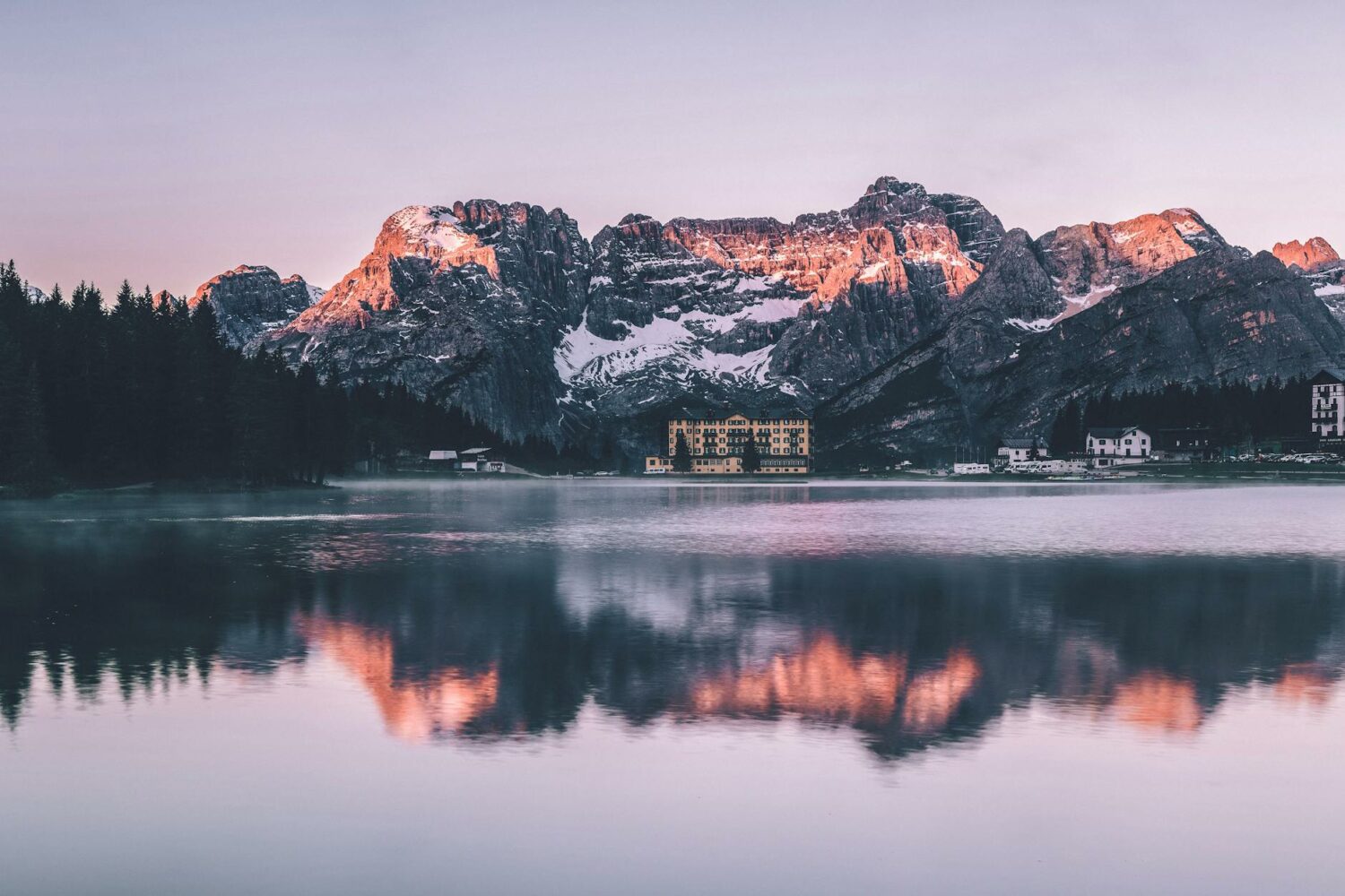 brown rocky mountain across body of water